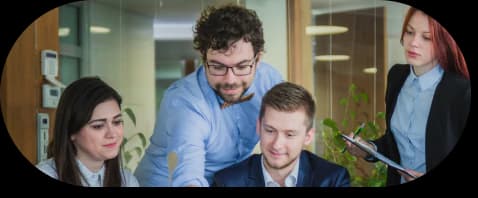 The TechDot team collaborating around a laptop